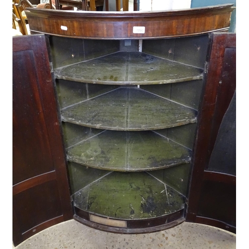 1590 - A George III mahogany hanging corner cupboard, with 2 panel doors and fitted shelves