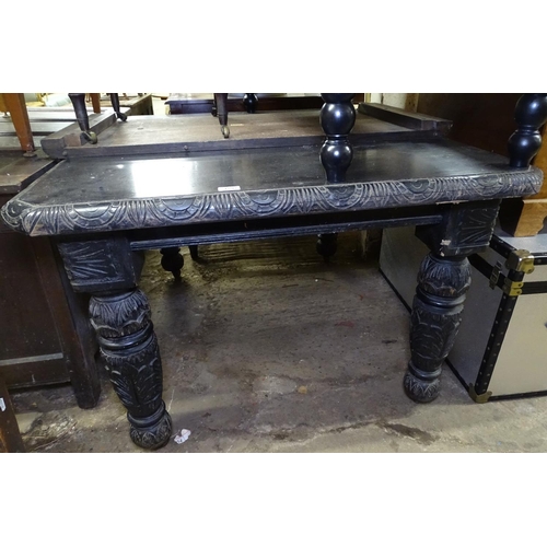 1597 - A Victorian carved oak wind-out dining table, together with 1 spare leaf, raised on heavy baluster t... 