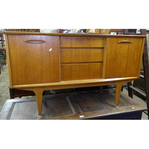 1598 - A mid-century teak sideboard, fitted with drawers and sliding cupboard doors, L127cm