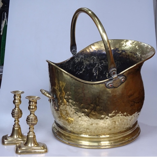 16 - A brass coal bucket, and a pair of candlesticks