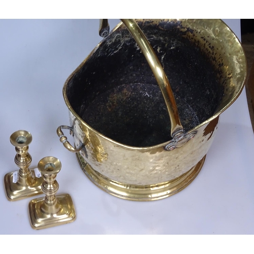 16 - A brass coal bucket, and a pair of candlesticks