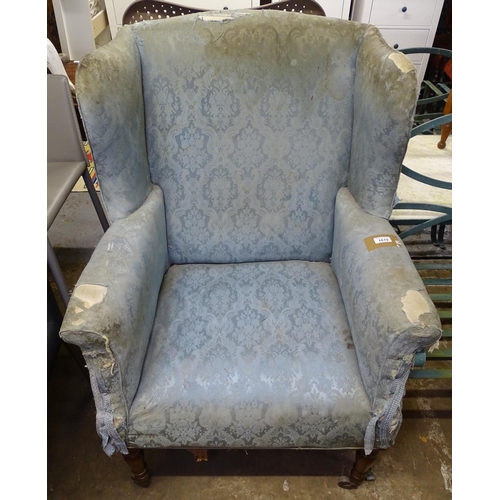 1615 - A Victorian upholstered wing-back armchair