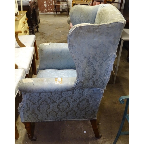 1615 - A Victorian upholstered wing-back armchair