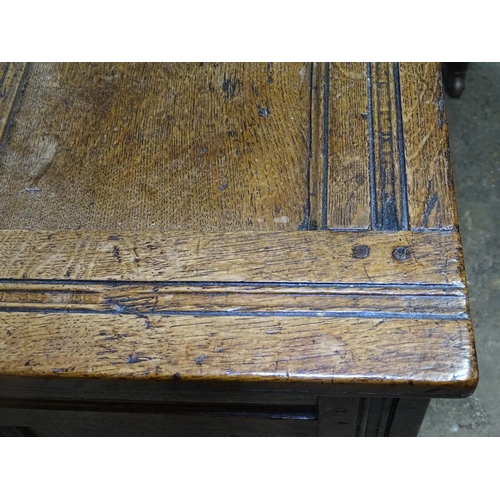 1620 - An 18th century joined oak coffer, with panelled front, on stile legs, W129cm