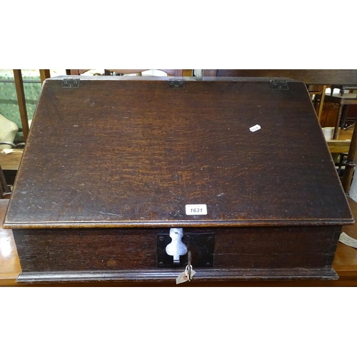 1631 - An 18th century oak clerk's writing slope, the rising lid revealing fitted drawers, with brass lock ... 