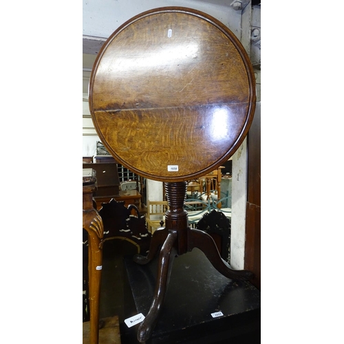 1658 - A Georgian oak tilt-top wine table, on ring turned column and tripod base