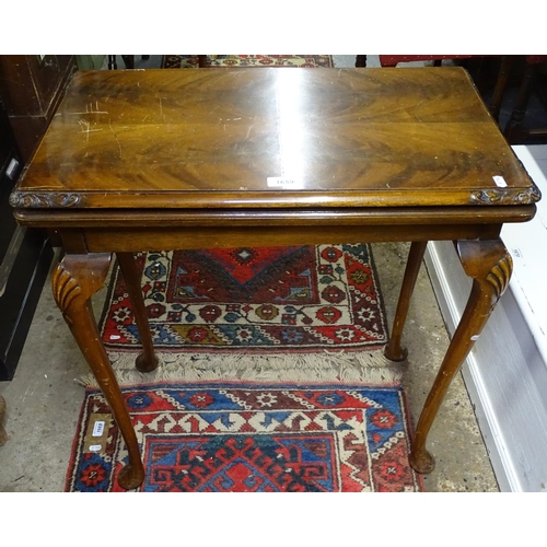 1659 - An Edwardian mahogany rectangular fold over card table, on shell carved cabriole legs, W67cm