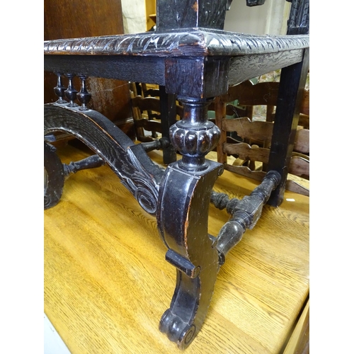 1672 - An ornate Victorian carved and panelled oak elbow-chair, with carved arms on scrolled supports, W50c... 