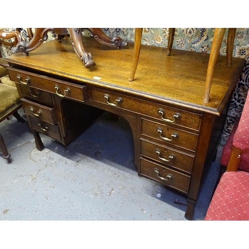 1675 - An early 20th century oak pedestal writing desk, by Spillman & Co, with 8 fitted drawers, W130cm, be... 