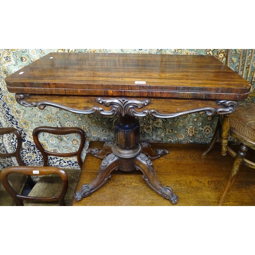 1677 - A Regency rosewood fold over card table, with applied moulded decoration, raised on a centre column ... 