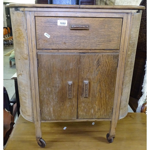 1680 - An Art Deco bow-end cocktail cabinet, with sliding cupboards under, W64cm