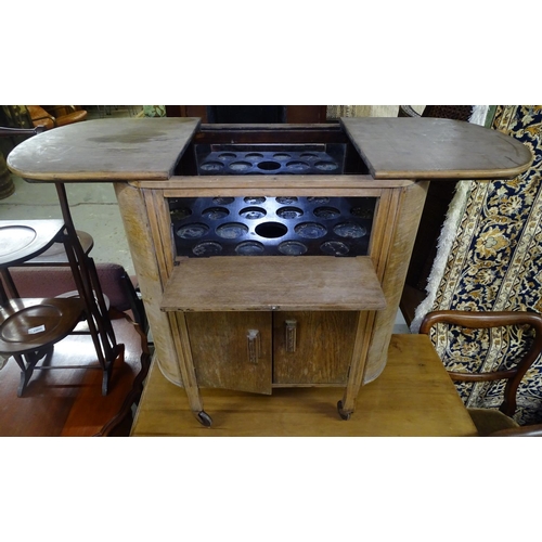 1680 - An Art Deco bow-end cocktail cabinet, with sliding cupboards under, W64cm