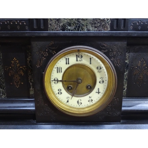 217 - A slate mantel clock with inset marble panels and 2-train movement, height 14