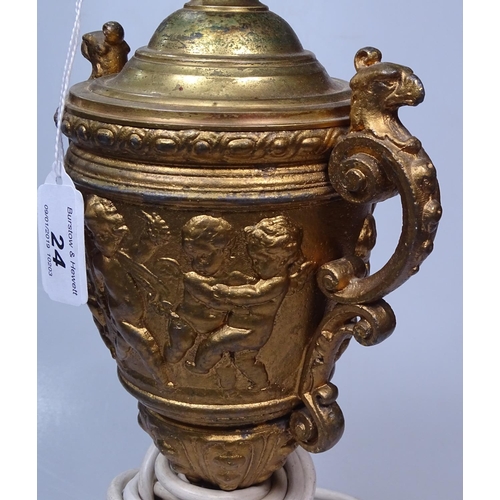 24 - A gilded metal table lamp with embossed cherubs frieze