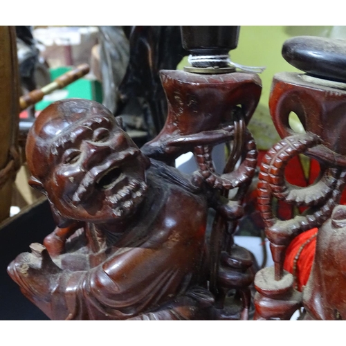 267 - A pair of Eastern carved hardwood figures with dogs, smallest 10