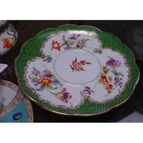 718 - A Dresden pot and cover on stand, and a Dresden miniature chocolate cup and cover on saucer