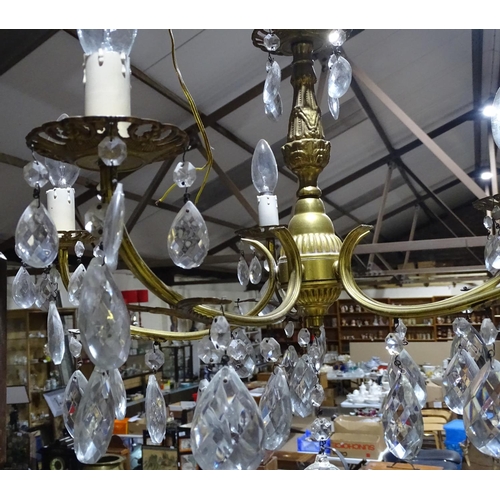 761 - A 5-branch brass chandelier with lustre drops