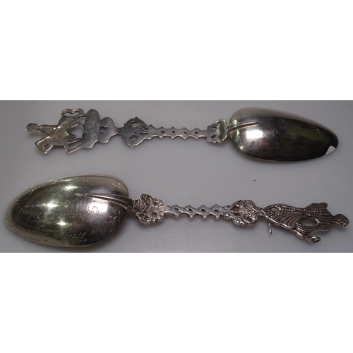 889 - A pair of Continental silver table spoons, with stylised handles depicting a sailor and soldier