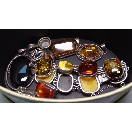 890 - A silver and amber panel bracelet, pendants, a ring etc