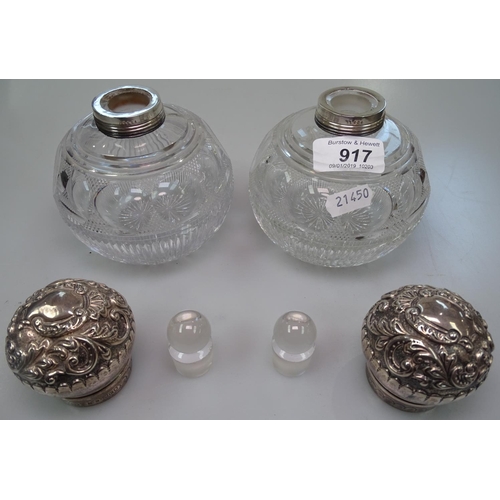 917 - A pair of large Victorian cut-glass and embossed silver-topped perfume bottles