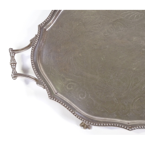 71 - A large silver plated oval tray, with beaded edge and claw and ball feet, length 72cm