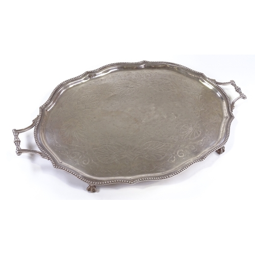 71 - A large silver plated oval tray, with beaded edge and claw and ball feet, length 72cm