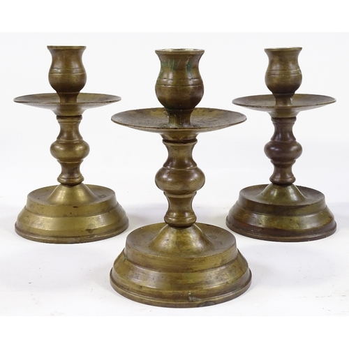 85 - A set of bronze candle stands, height 14cm