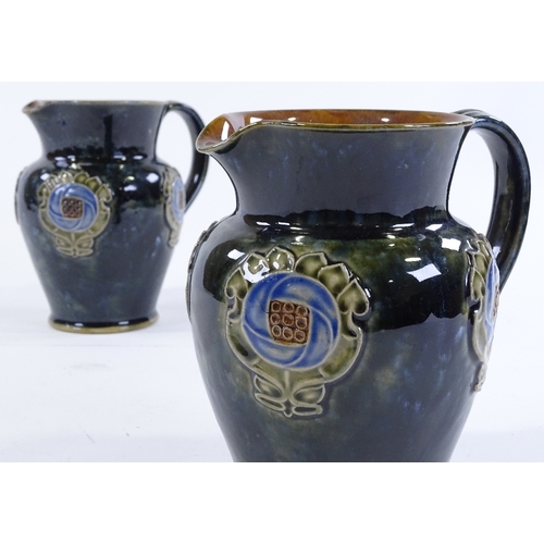 142 - A pair of Royal Doulton stoneware jugs, with relief moulded floral decoration, height 16cm