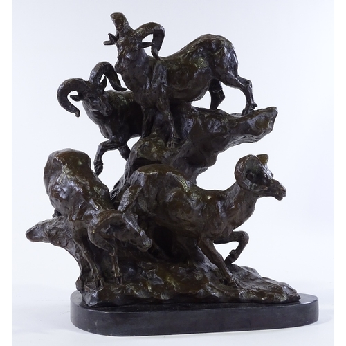 147 - A patinated bronze sculpture depicting mountain goats on a rocky outcrop, black marble plinth, indis... 