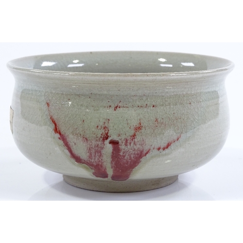 149 - A Chinese celadon glaze porcelain bowl, with flashes of iron red colour, diameter 13cm