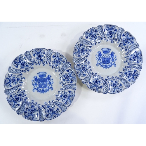 154 - A pair of Delft tin-glazed pottery plates, with moulded surrounds and armorial centres, diameter 27c... 