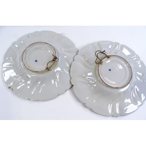 154 - A pair of Delft tin-glazed pottery plates, with moulded surrounds and armorial centres, diameter 27c... 