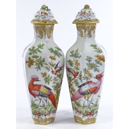 155 - A pair of porcelain vases and covers, circa 1900, hand painted exotic birds and flowers, with gold a... 