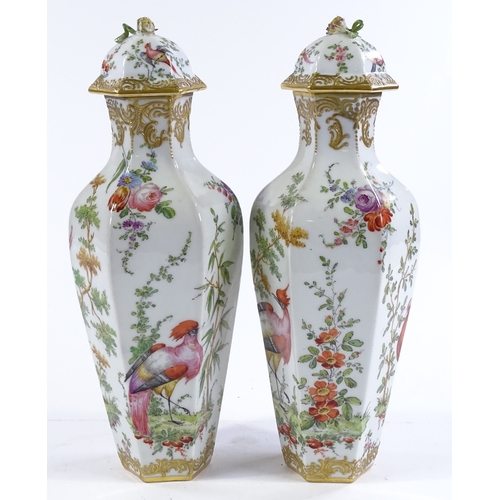 155 - A pair of porcelain vases and covers, circa 1900, hand painted exotic birds and flowers, with gold a... 