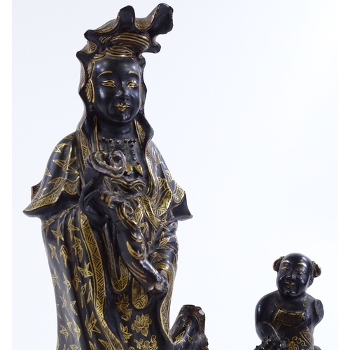 156 - A Chinese gilded and black glaze ceramic figure of Buddha, on wave design base, height 24cm