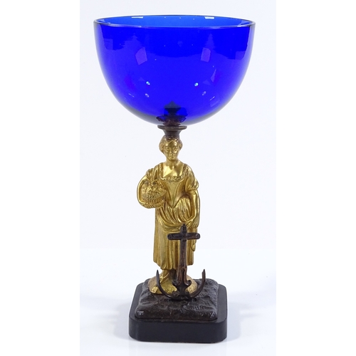 182 - A 19th century Bristol blue glass bowl, supported by a gilt-bronze Classical figure beside an anchor... 