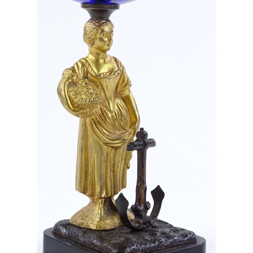 182 - A 19th century Bristol blue glass bowl, supported by a gilt-bronze Classical figure beside an anchor... 