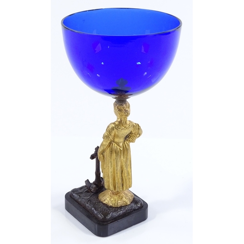 182 - A 19th century Bristol blue glass bowl, supported by a gilt-bronze Classical figure beside an anchor... 