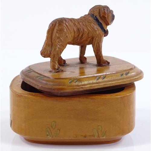 185 - A small Black Forest carved wood box surmounted by a dog, length 6cm