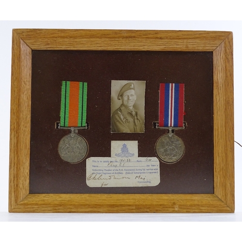 189 - A framed pair of Second War Service medals, awarded to 1741521 Gnr G E Keily RA