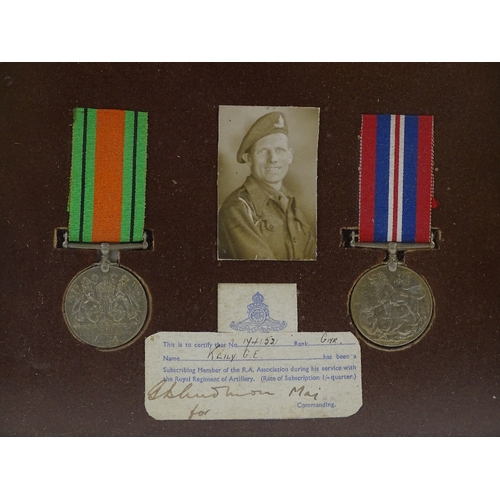 189 - A framed pair of Second War Service medals, awarded to 1741521 Gnr G E Keily RA