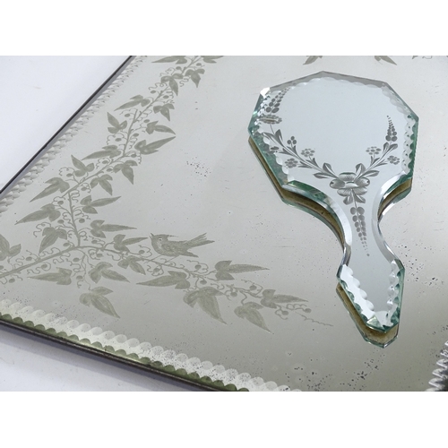 198 - A Victorian wall mirror with etched vine decoration, 46cm x 33cm, and a similar hand mirror (2)