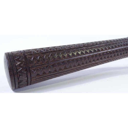 65 - A carved and mother-of-pearl inlaid hardwood Tribal club, length 47cm