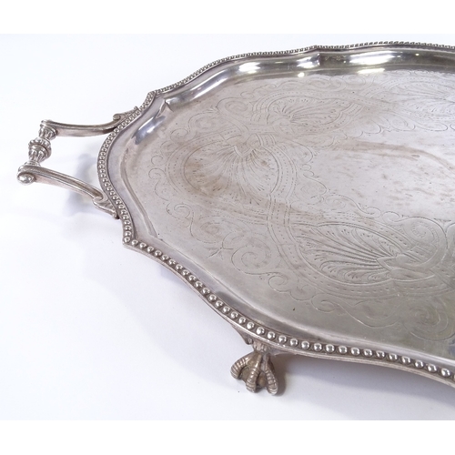 71 - A large silver plated oval tray, with beaded edge and claw and ball feet, length 72cm