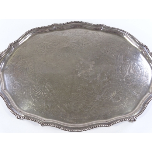 71 - A large silver plated oval tray, with beaded edge and claw and ball feet, length 72cm