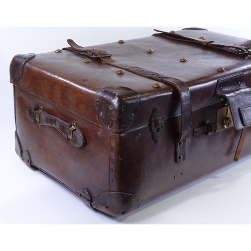 82 - A large brown leather travelling trunk with brass studs, 82cm x 47cm x 34cm