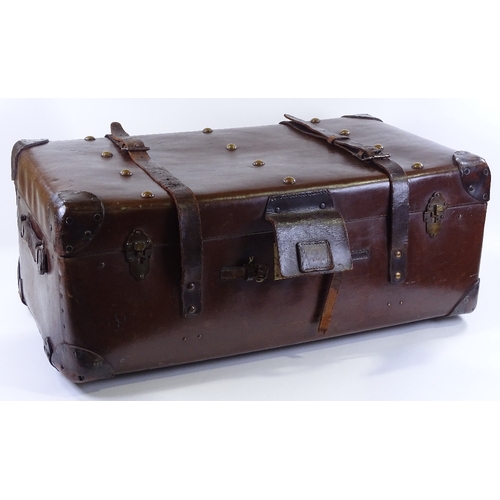 82 - A large brown leather travelling trunk with brass studs, 82cm x 47cm x 34cm