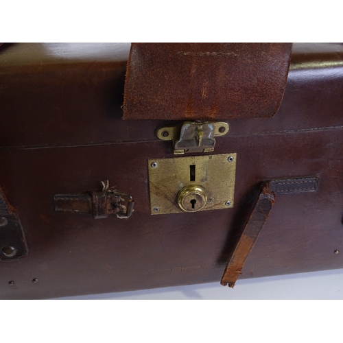 82 - A large brown leather travelling trunk with brass studs, 82cm x 47cm x 34cm