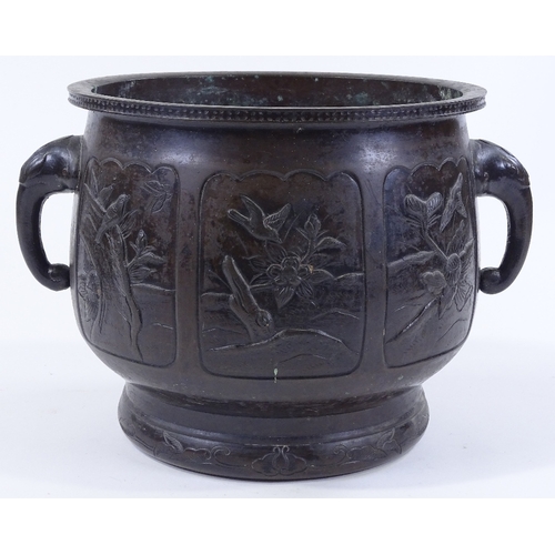 84 - A Chinese relief cast bronze 2-handled jardiniere, with shaped moulded panels depicting exotic birds... 