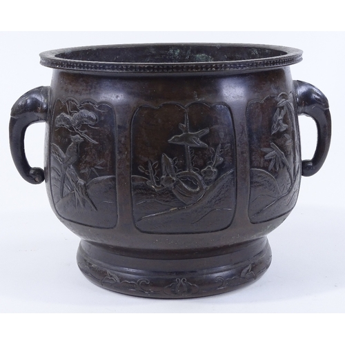 84 - A Chinese relief cast bronze 2-handled jardiniere, with shaped moulded panels depicting exotic birds... 